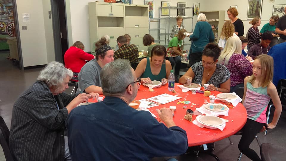 Artist Guild members working on a project at a meeting.